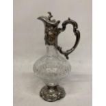 AN ORNATE SILVER PLATED AND CUT GLASS CLARET JUG