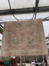 A PINK RUG WITH ORIENTAL DRAGON DESIGN