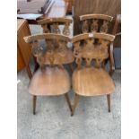 A SET OF FOUR ERCOL ELM AND BEECH FLEUR DE LYS DINING CHAIRS