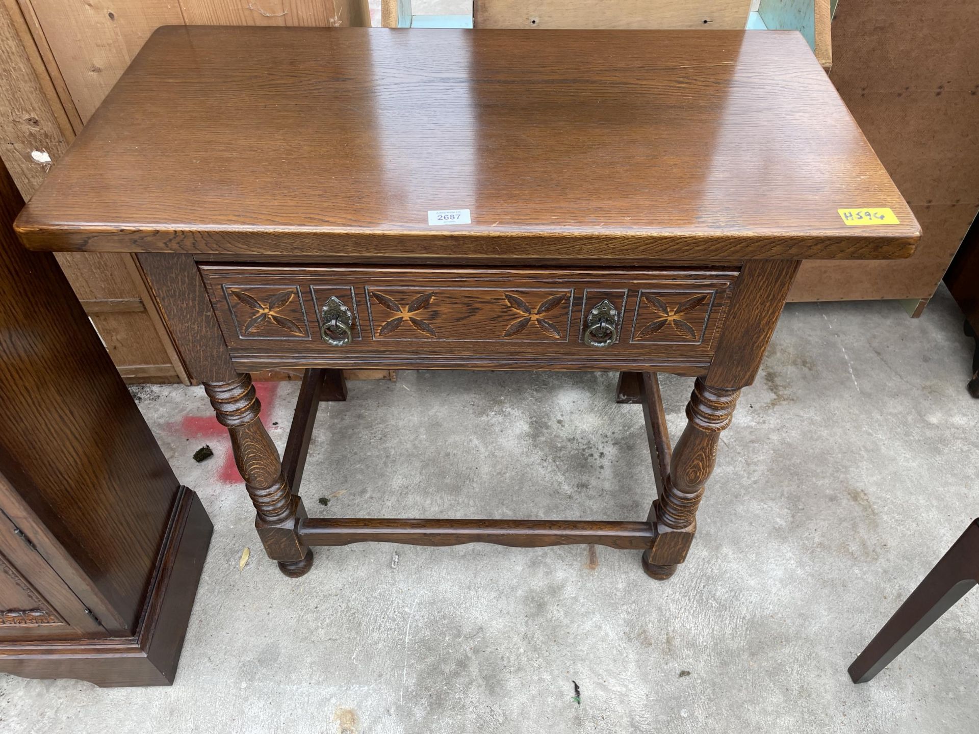 AN OAK JACOBEAN STYLE SIDE-TABLE WITH SINGLE DRAWER ON TURNED FRONT LEGS, 32" WIDE