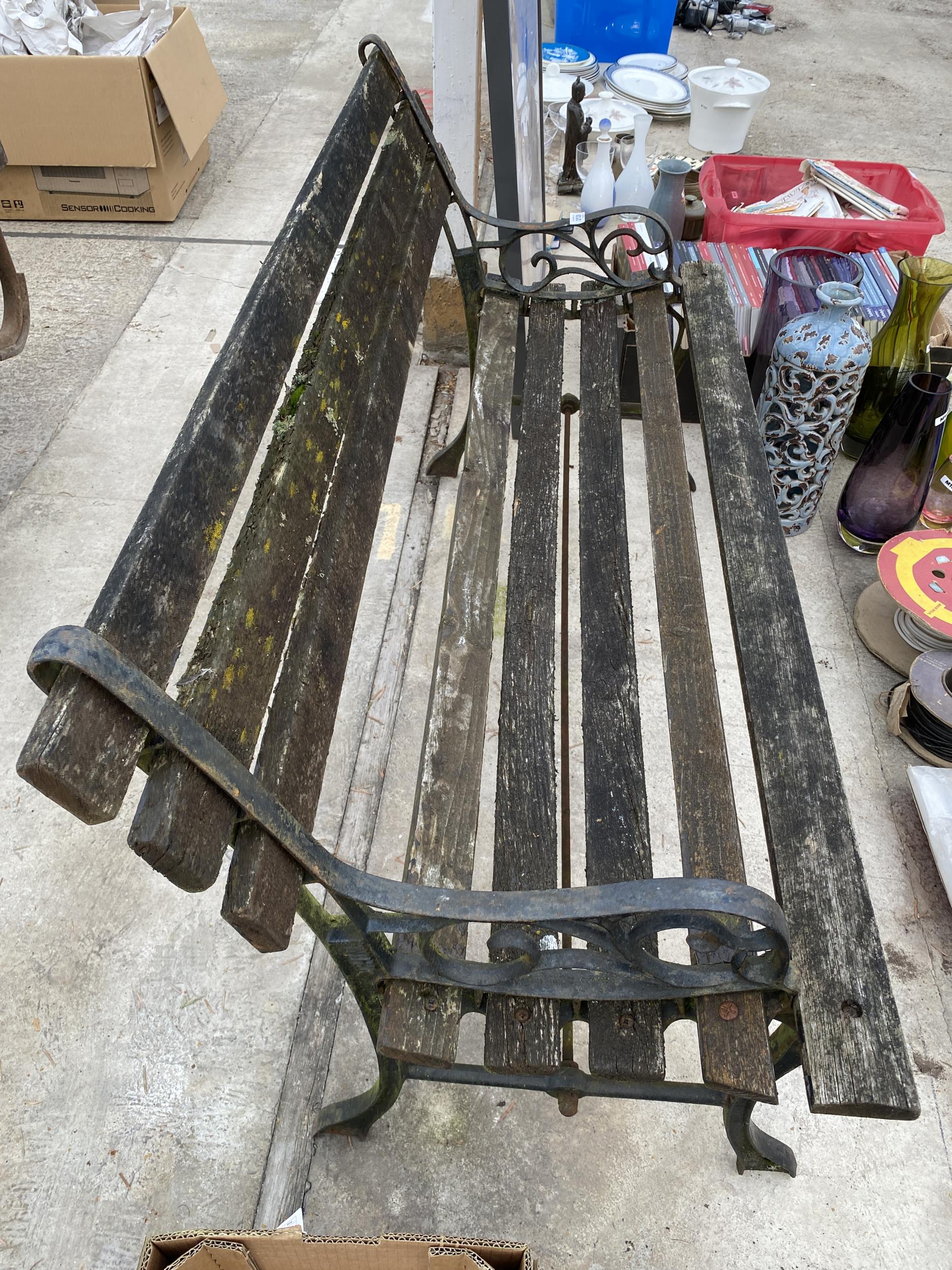 A WOODEN SLATTED GARDEN BENCH WITH CAST BENCH ENDS - Image 2 of 2