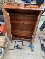 A WOODEN WALL TOOL CABINET, A VICE AND A DRILL