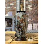 A LARGE ORNATE TABLE LAMP WITH FLORAL DESIGN