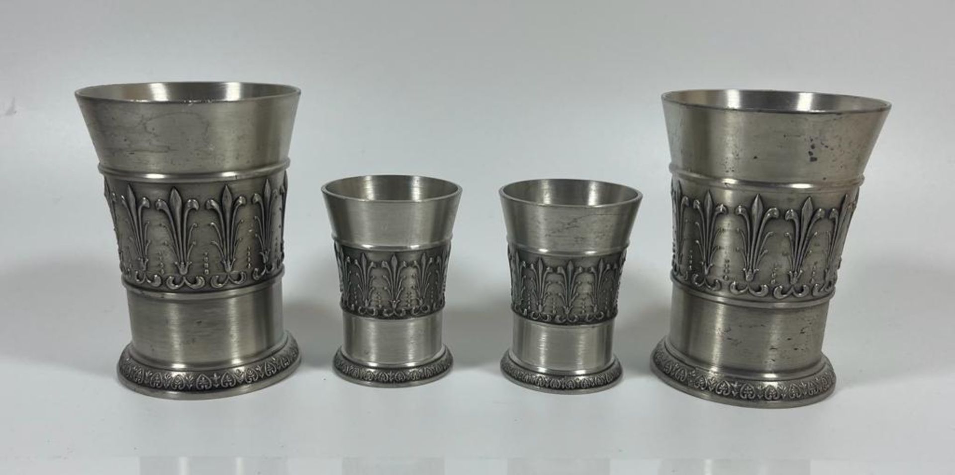 A SET OF FOUR SKS ZINN 95% PEWTER DRINKING GLASSES, HEIGHT OF LARGEST PAIR 9 CM