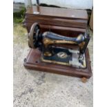 A VINTAGE SINGER SEWING MACHINE WITH WOODEN CARRY CASE