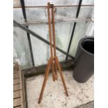 A WOODEN FOLDING TRIPOD ARTISTS EASLE