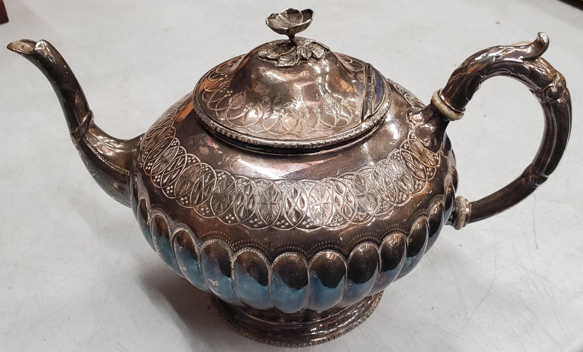 AN ORNATE SILVER PLATED VICTORIAN TEAPOT