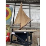 A VINTAGE WOODEN MODEL OF A SHIP ON A STAND