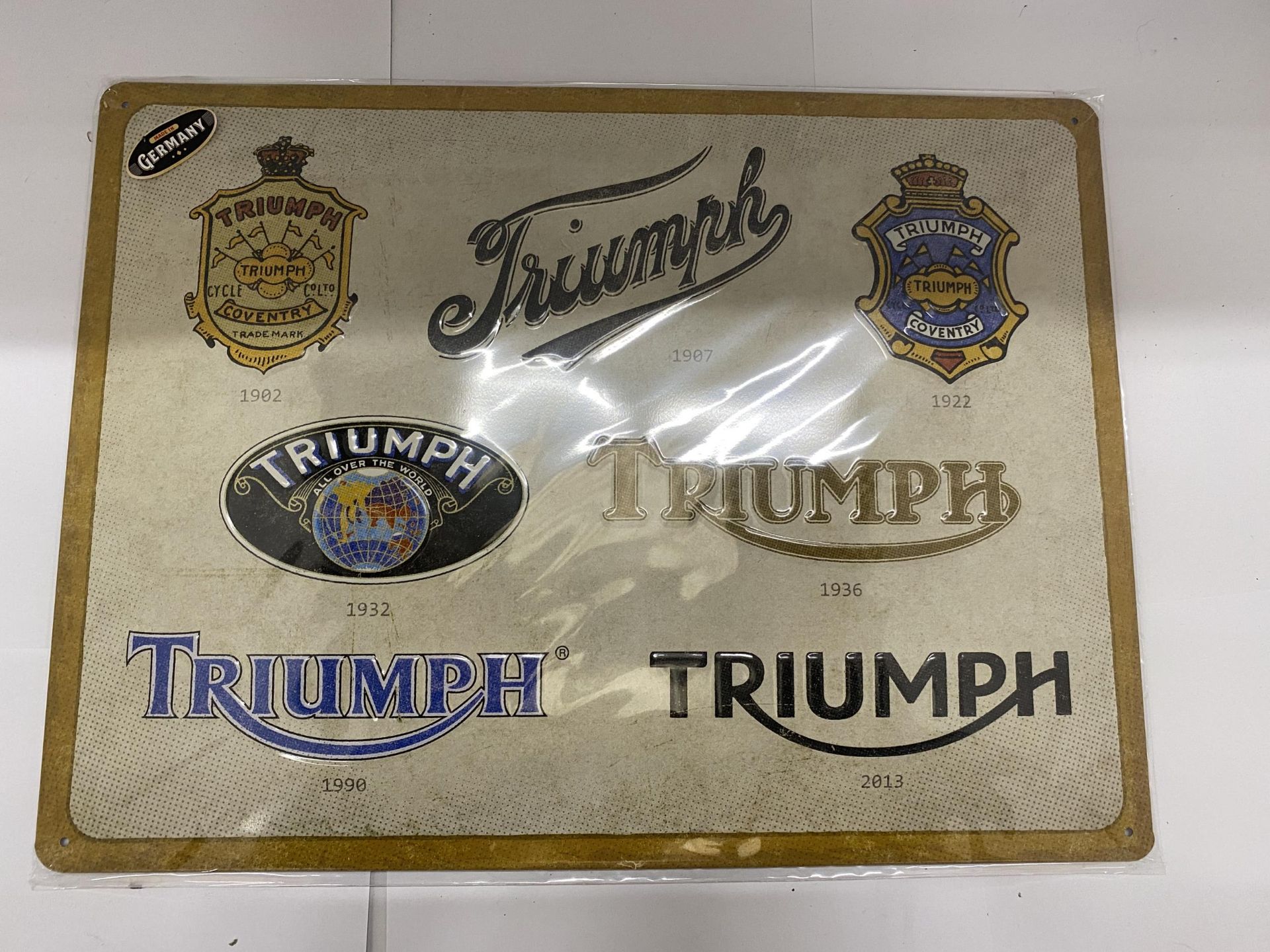 A METAL TRIUMPH SIGN 39CM X 29CM