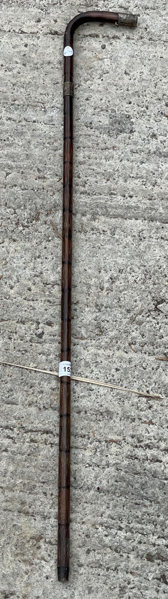 A VINTAGE WOODEN WALKING STICK WITH HALLMARKED SILVER COLLARS