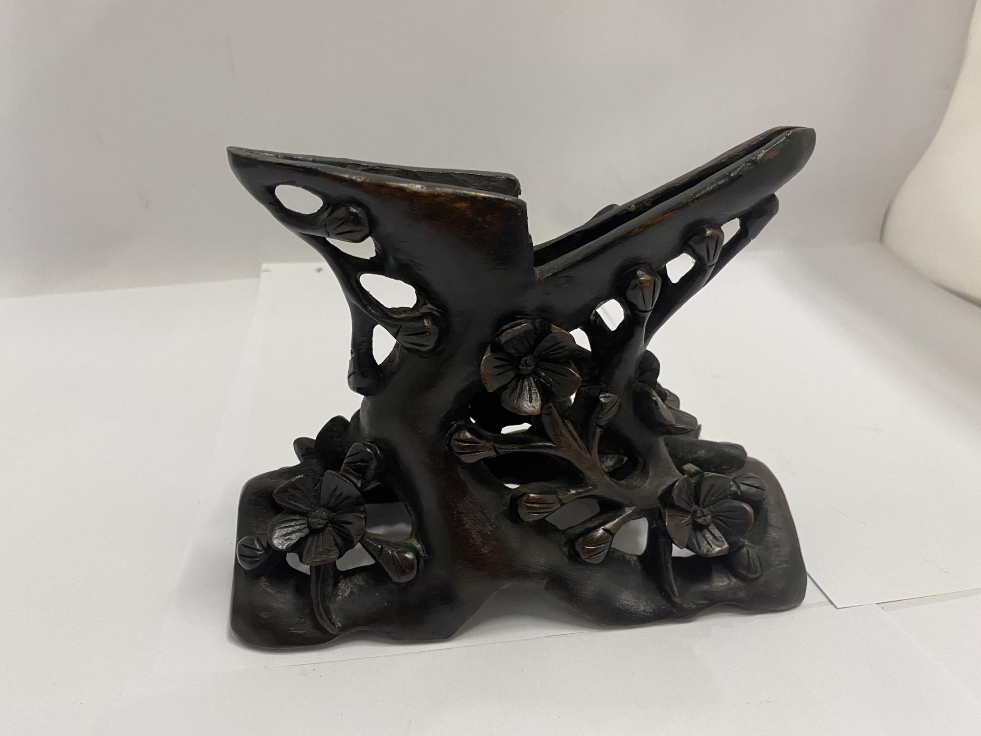 A WOODEN ORIENTAL CARVED STAND