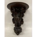 A MID 19TH CENTURY HEAVILY CARVED BLACK FOREST WALL SCONCE