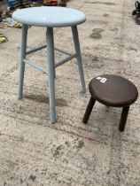 A VINTAGE THREE LEGGED MILKING STOOL AND A FURTHER WOODEN STOOL