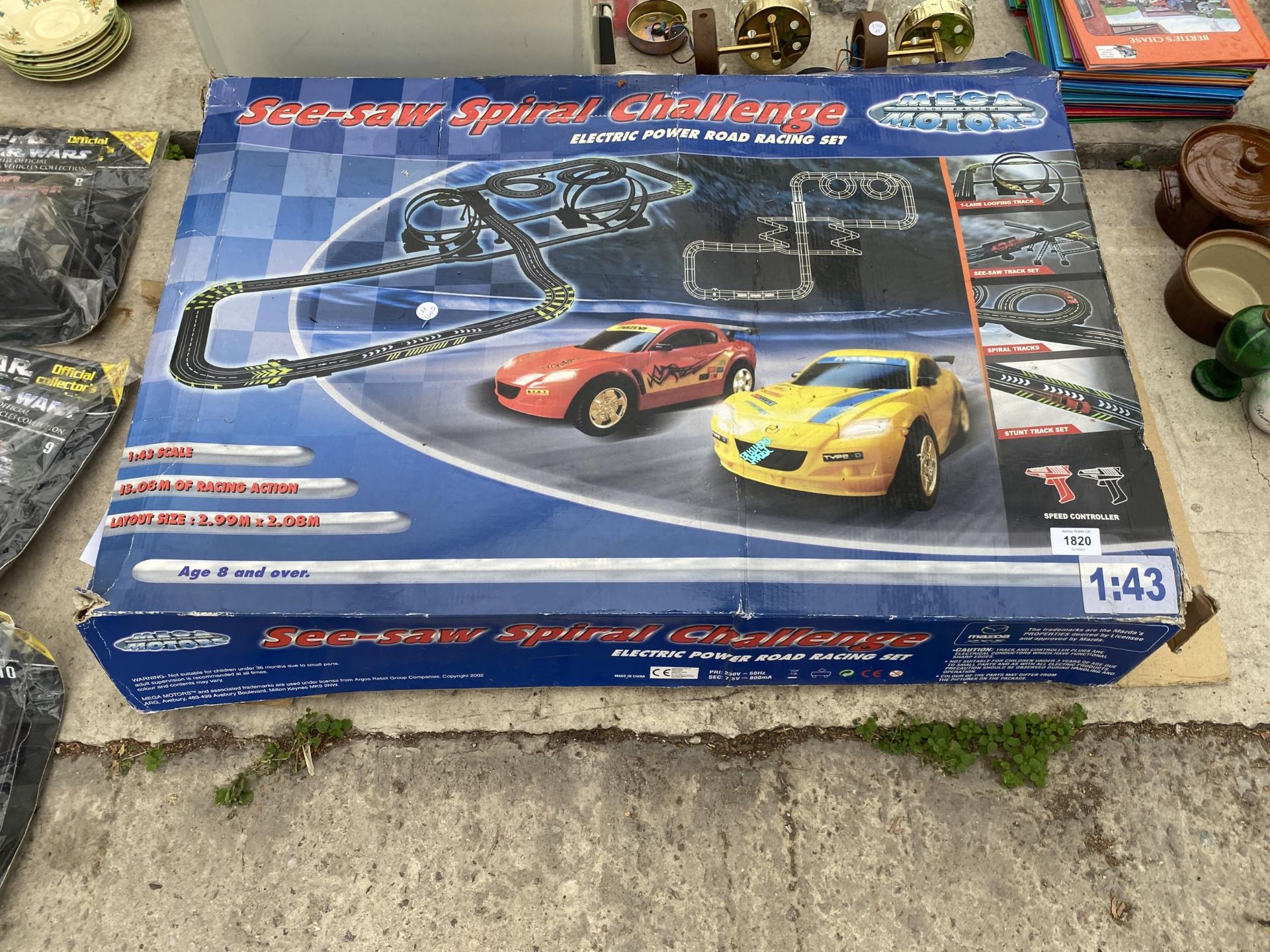 A BOXED MEGA MOTORS SEE-SAW SPIRAL RACE TRACK