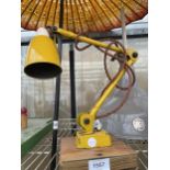 A RETRO YELLOW ANGLE POISE STYLE LAMP ON A WOODEN BASE