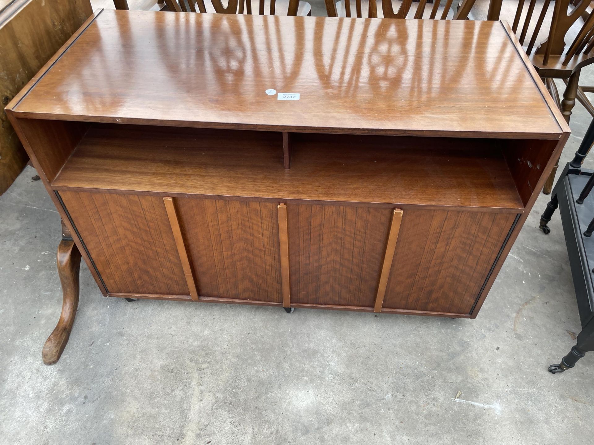 A RETRO TEAK CABINET WITH PAIR OF BI-FOLD DOORS TO THE BASE, 36" WIDE