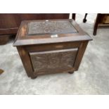 A HEAVILY CARVED OAK COAL BOX WITH GALVANISED LINER