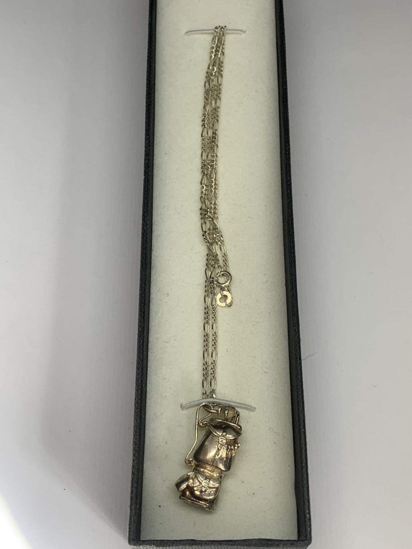 A BOXED SILVER GOLF BAG NECKLACE