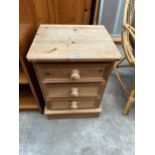 A PINE THREE DRAWER BEDSIDE CHEST
