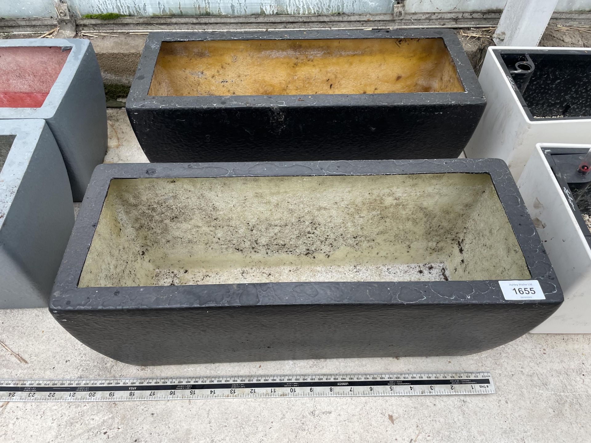 A PAIR OF LOW FIBRE GLASS TROUGH PLANTERS (L:50CM)