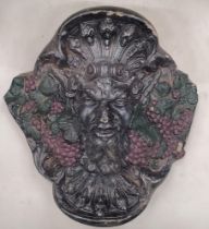 A HEAVY WALL HANGING STONE FACE OF BACCHUS, THE GOD OF WINE AND FRIVOLITY, APPROX 28CM X 28CM