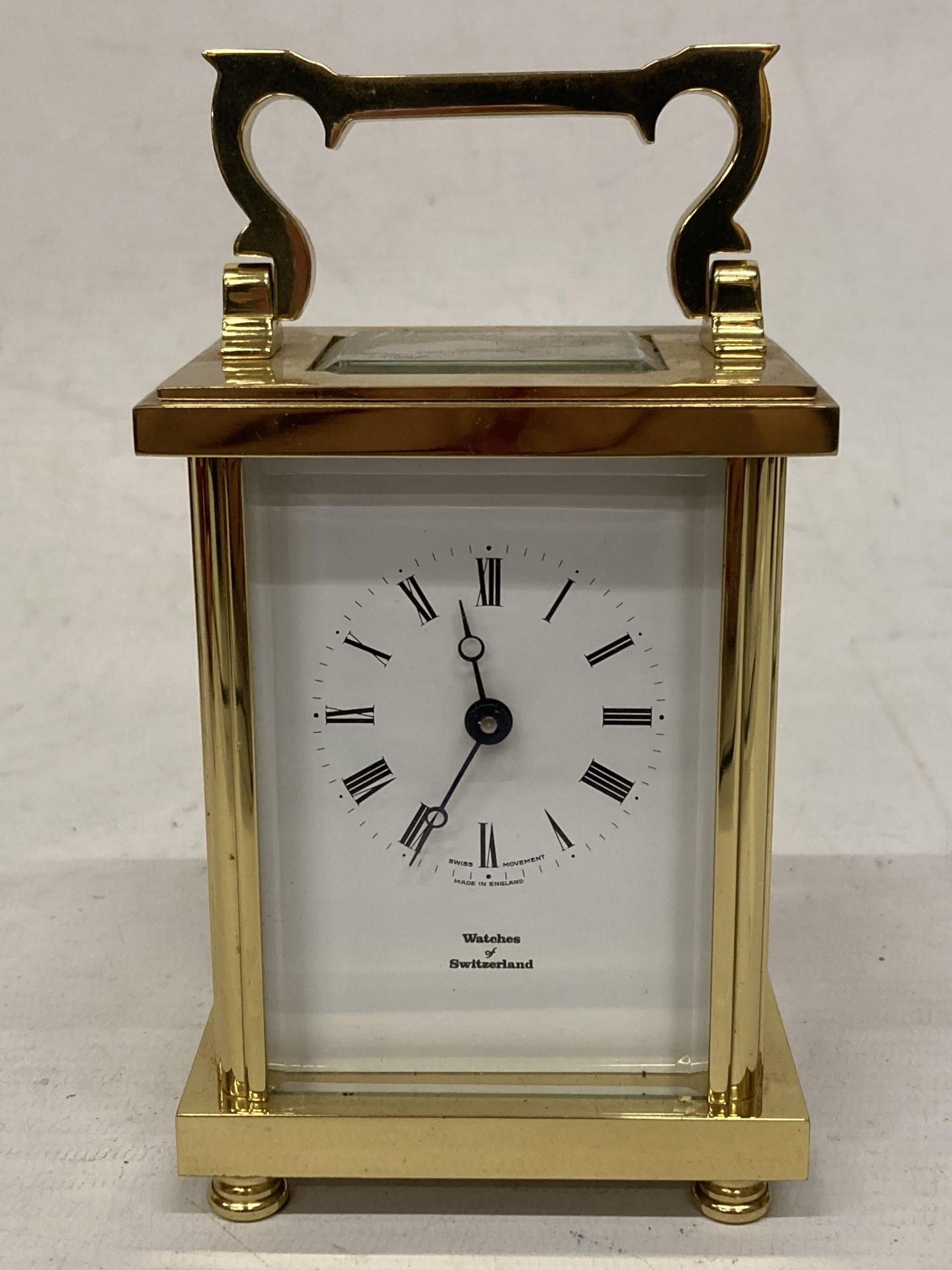 A WATCHES OF SWITZERLAND BRASS CARRIAGE CLOCK