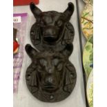 A PAIR OF VERY HEAVY CAST IRON 3-D BULLS HEAD PLAQUES