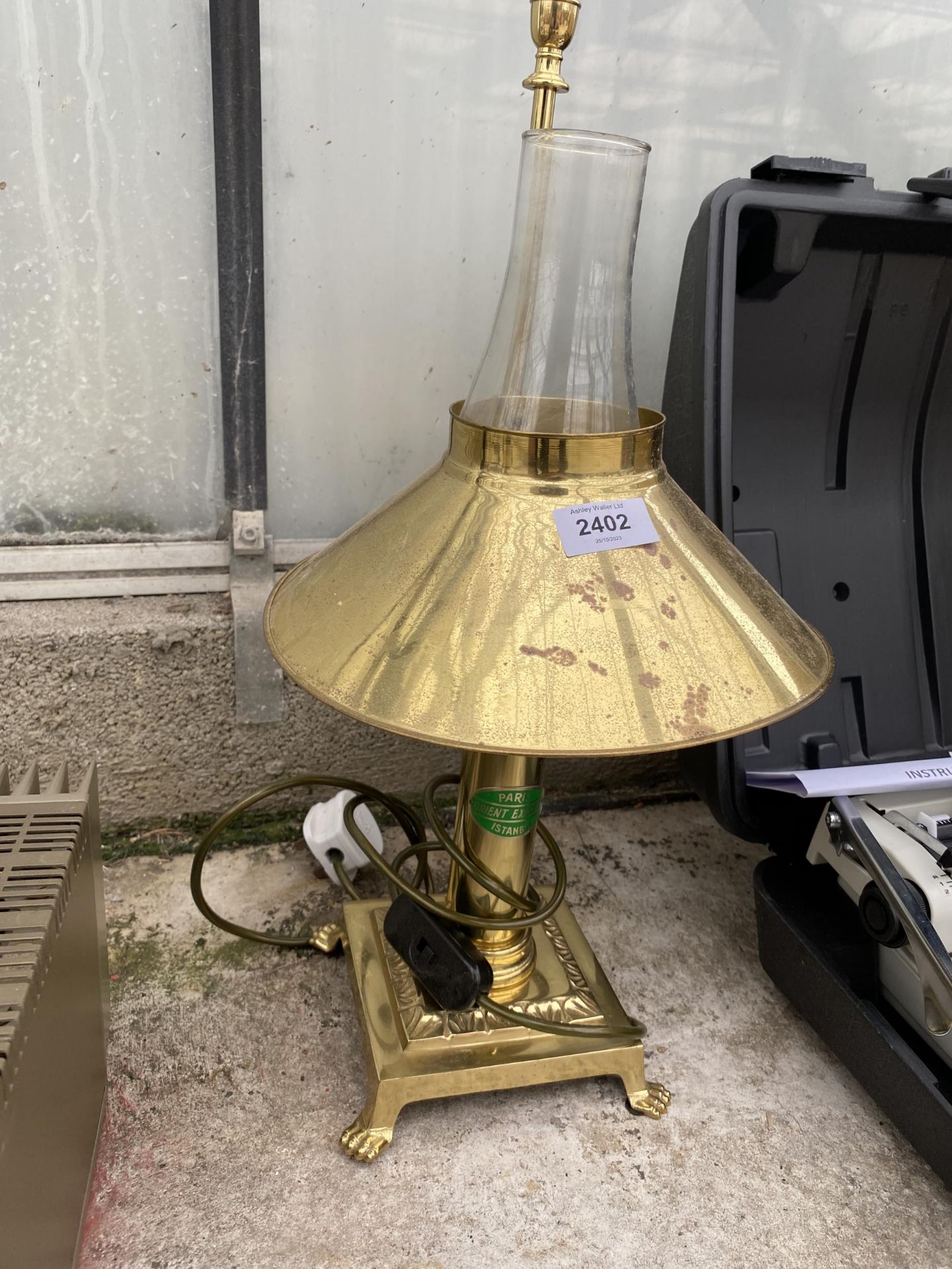A BRASS ELECTRIC TABLE LAMP WITH LION PAW FEET