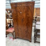 A MAHOGANY TWO DOOR WARING & GILLOW WARDROBE, 38" WIDE, ON OGEE FEET