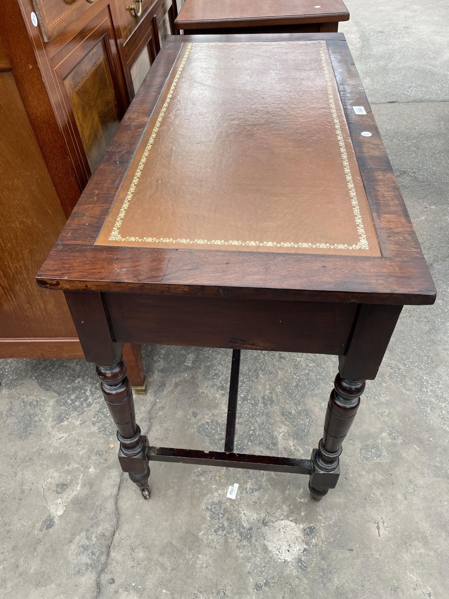 A LATE VICTORIAN SIDE-TABLE WITH TWO DRAWERS, ON TURNED LEGS, WITH INSET LEATHER TOP, 42" WIDE - Image 3 of 3