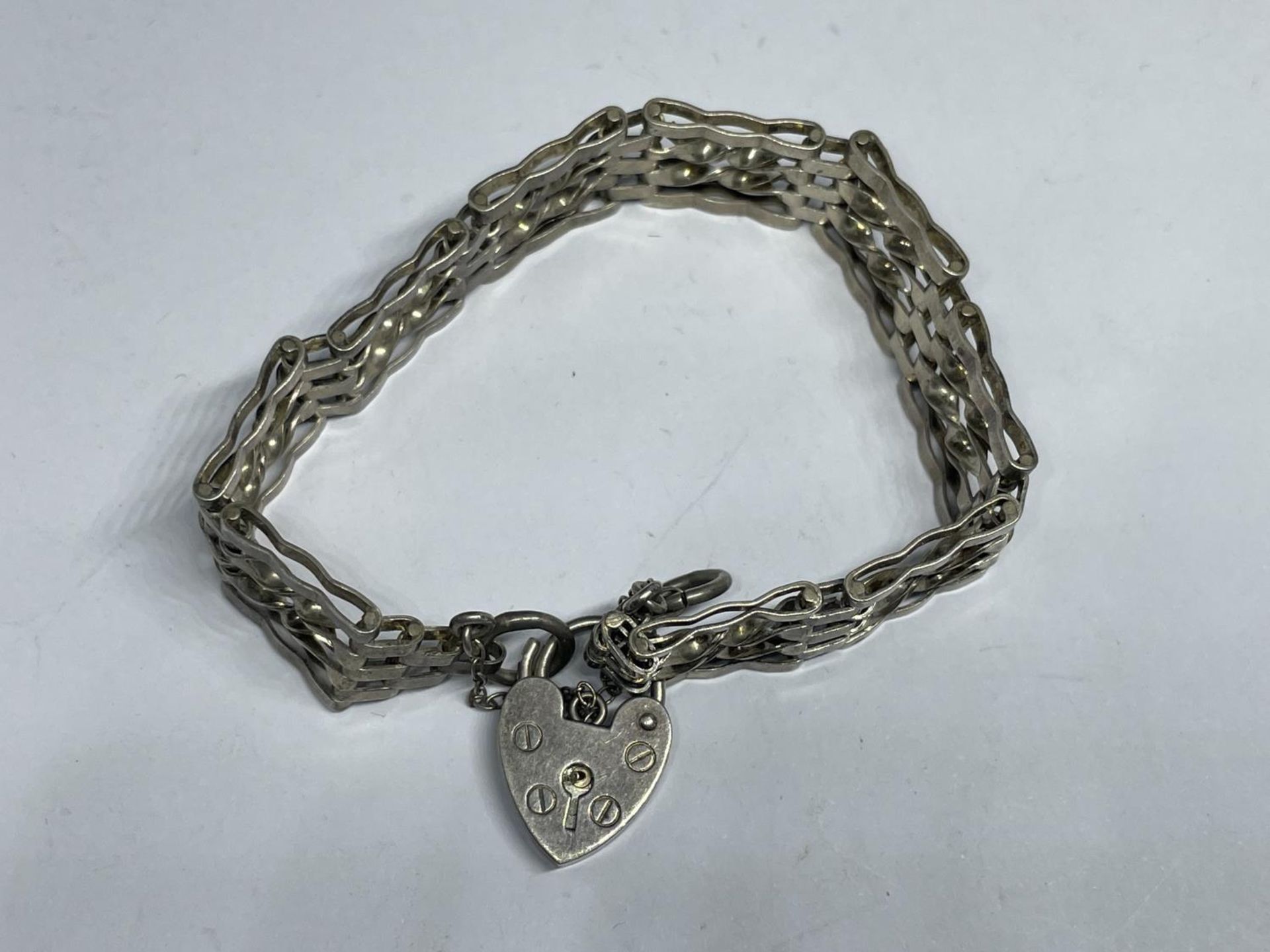 A MARKED SILVER FOUR BAR GATE BRACELET WITH HEART PADLOCK AND SAFETY CHAIN WEIGHT 15.2 GRAMS - Image 2 of 3