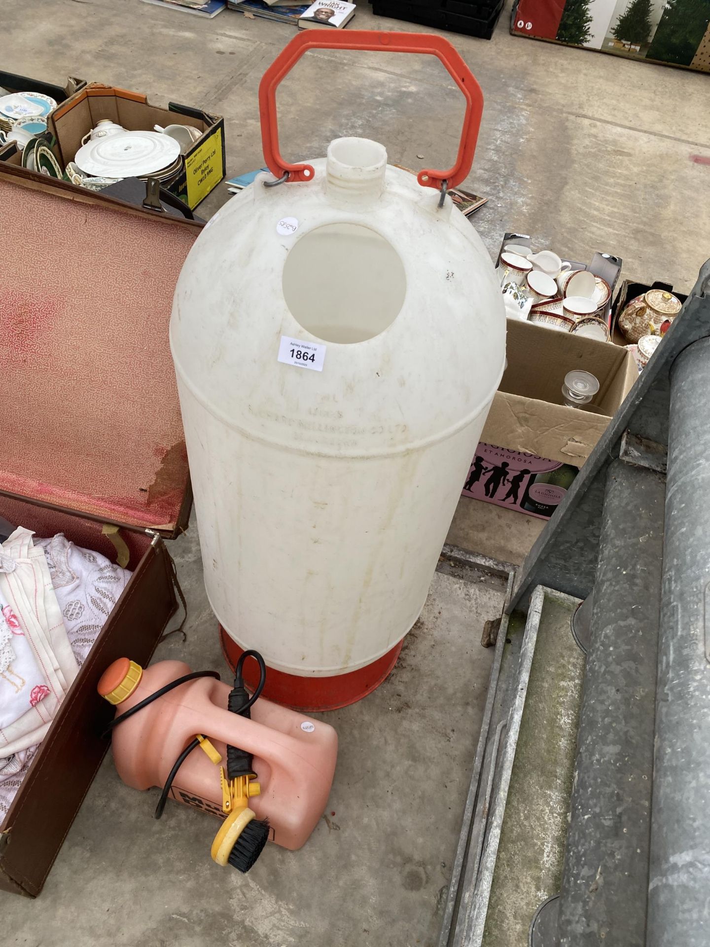 A PLASTIC POULTRY DRINKER AND A MUD WASHING BRUSH