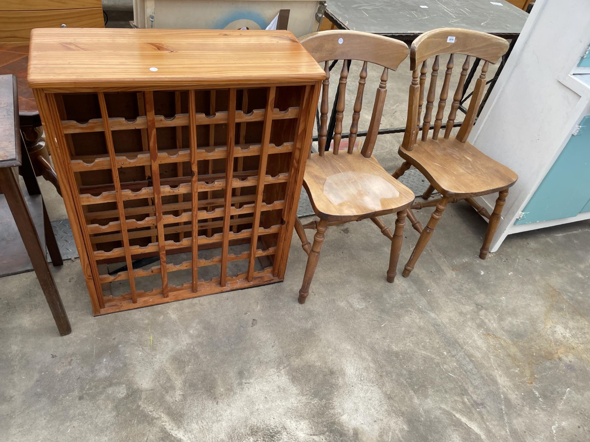 A PINE FORTY-TWO BOTTLE WINE RACK AND A PAIR OF KITCHEN CHAIRS