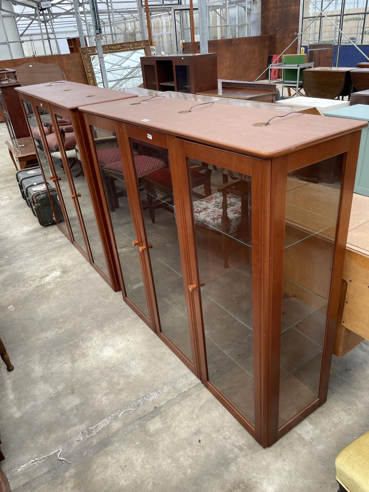 A PAIR OF MODERN THREE DOOR GLASS FRONTED DISPLAY CABINETS, 51.5" WIDE, 15.5" DEEP AND 47" HIGH