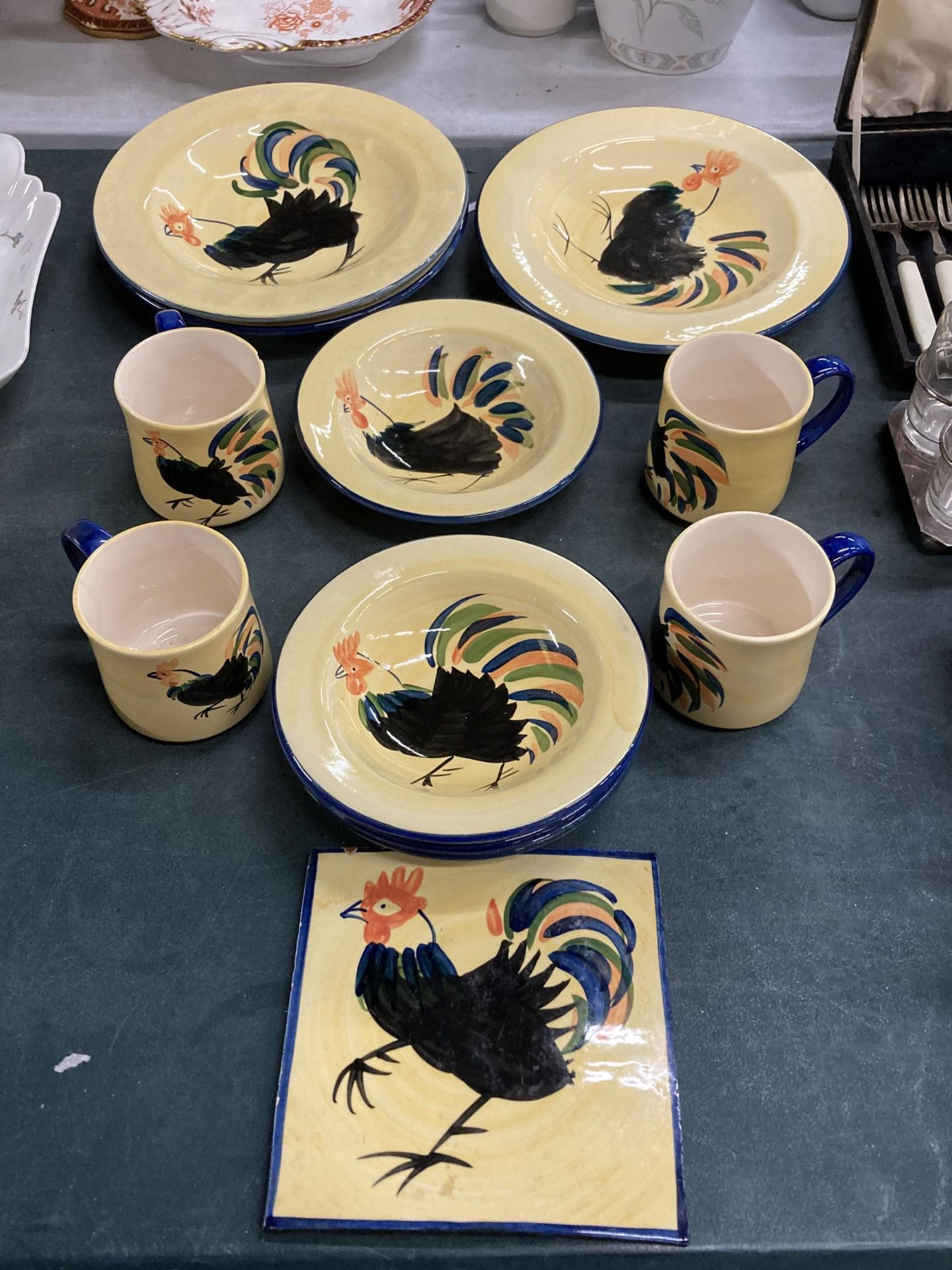 A COLLECTION OF HOLDENBY HEN POTTERY ITEMS, MUGS, PLATES ETC