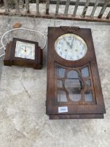 AN OAK CASED CHIMING WALL CLOCK AND A FURTHER OAK MANTLE CLOCK