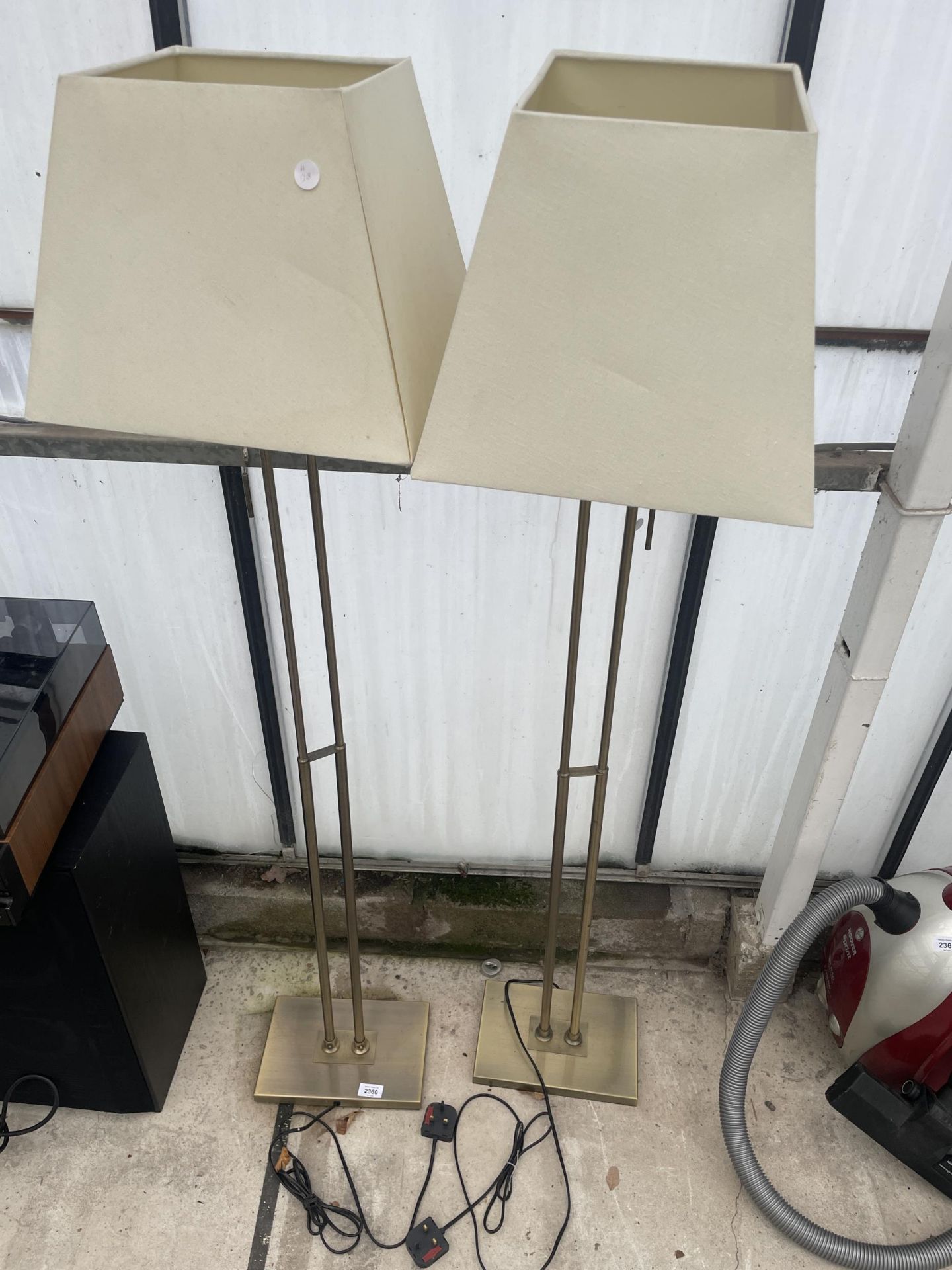 A PAIR OF DECORATIVE METAL STANDARD LAMPS WITH SHADES