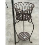 A VINTAGE METAL PLANT STAND WITH WIRE BASKET TOP