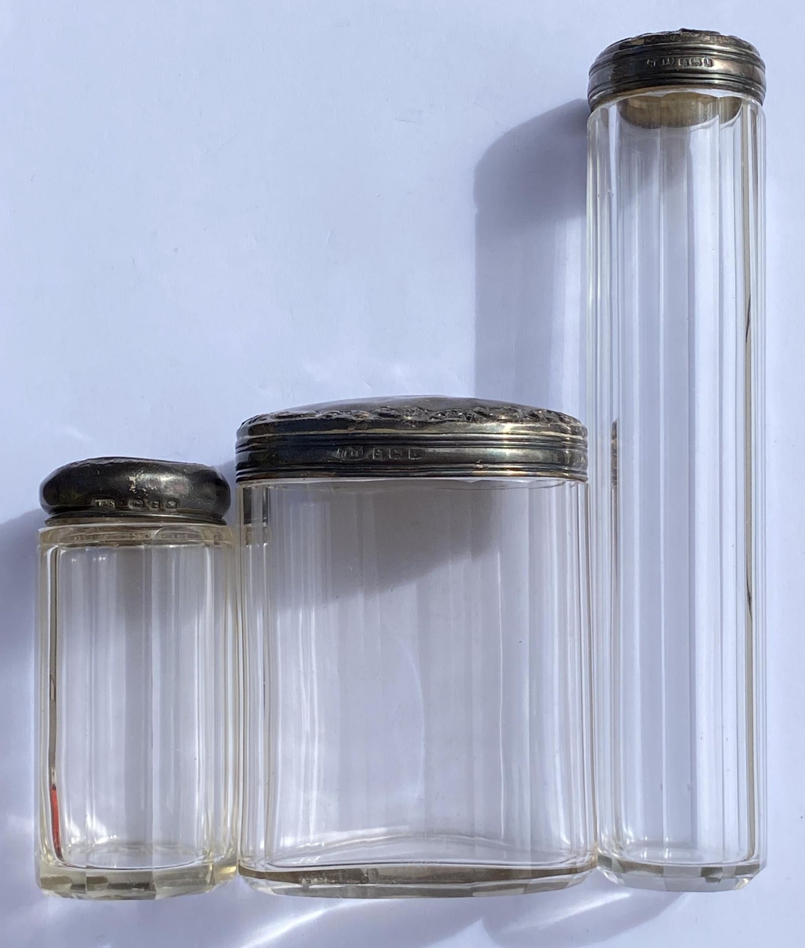 A GROUP OF THREE SILVER TOPPED DRESSING TABLE POTS, 2 X 1910 AND 1 X 1924, HEIGHT OF TALLEST 16