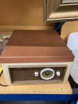 A KB RADIO TUNETIME VINTAGE RECORD PLAYER IN A CASE