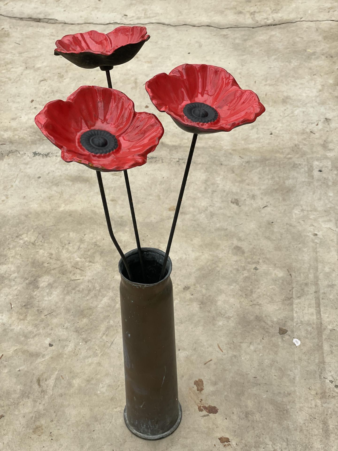 A WORLD WAR TWO ARTILLERY SHELL WITH STEEL REMEMBRANCE POPPIES