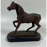 A VINTAGE CAST IRON OR SPELTER MODEL OF A HORSE ON A WOODEN BASE, HEIGHT 16CM
