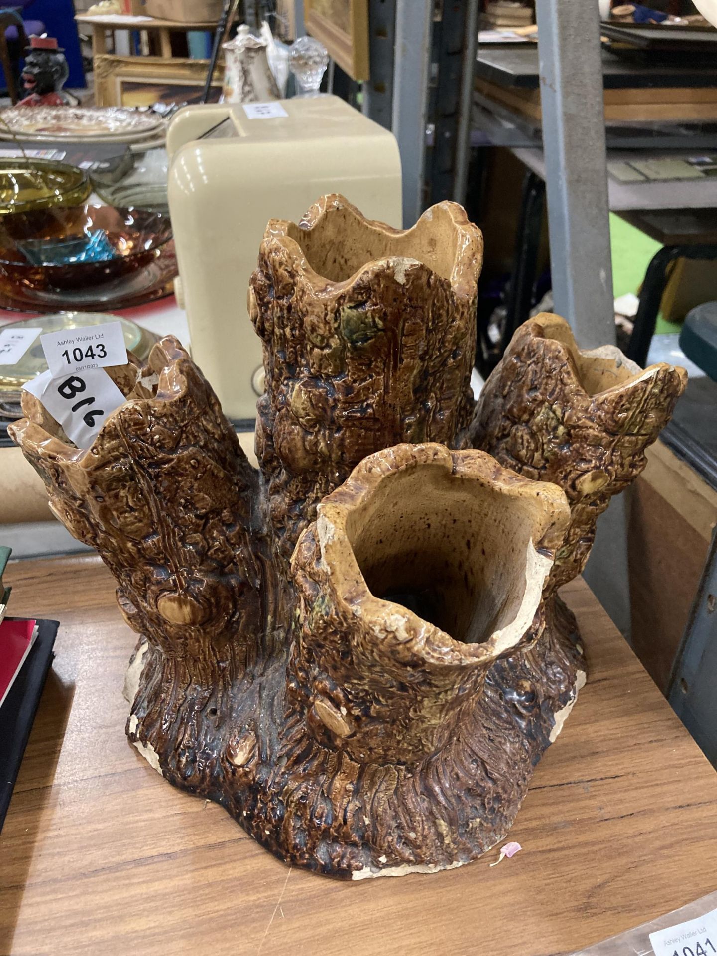 A POTTERY TREE TRUNK DESIGN UMBRELLA STAND