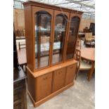A 'MORRIS FURNITURE COMPANY' THREE DOOR DISPLAY CABINET ON BASE ENCLOSING THREE CUPBOARDS, 48" WIDE