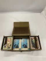 A VINTAGE LEATHER PLAYING CARD BOX WITH PLAYING CARDS