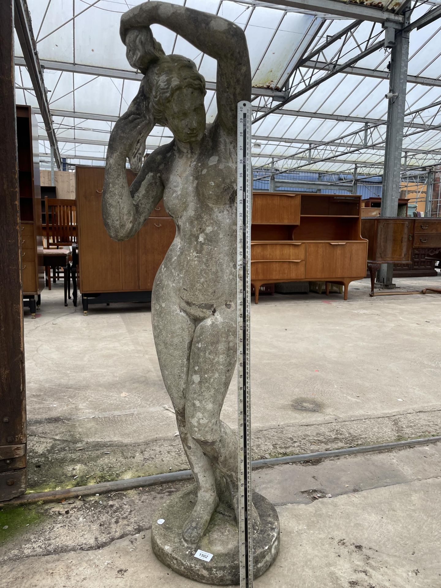 A CONCRETE GARDEN FIGURE OF A FEMALE (H:119CM)