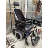 A QUICKIE ELECTRIC WHEEL CHAIR (CHARGER IN THE OFFICE)