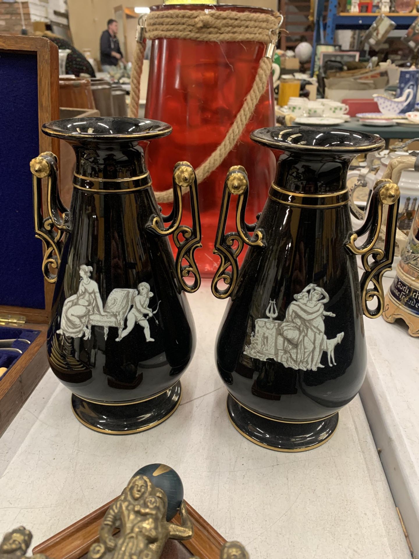 A PAIR OF GRECIAN STYLE BLACK AND GOLD VASES
