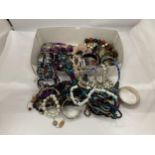 A QUANTITY OF COSTUME JEWELLERY TO INCLUDE BANGLES, NECKLACES, BRACELETS, ETC