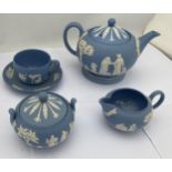 A WEDGWOOD PALE BLUE JASPERWARE TEA FOR ONE BACHELOR SET COMPRISING TEAPOT, SUGAR BOWL, CREAM JUG